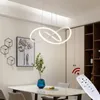 A modern dining room with a pendant light, artwork, and a remote control. Produktbild-Vorschau