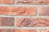A close-up view of a brick wall texture. Produktbild-Vorschau
