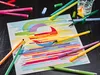 A collection of STABILO pens and a drawing on a dark surface. Náhled obrázku produktu