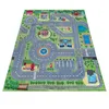 A colorful children's play rug depicting a city street scene with roads, buildings, a park, and a playground. Produktbild-Vorschau