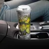 A portable blender filled with ingredients is placed in a car's cup holder. Podgląd zdjęcia produktu