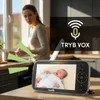 A woman is in a kitchen, looking concerned, while a baby monitor displays a crying baby. Sound waves emanate from the baby monitor. Náhled obrázku produktu