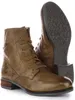 A pair of brown leather boots are shown against a white background. One boot is upright and the other is lying on its side, showing the sole. Produktbild-Vorschau