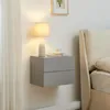 A modern bedroom scene with a wall-mounted nightstand next to a bed. Produktbild-Vorschau