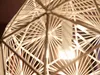 Close-up view of a light bulb inside a decorative lampshade. Produktbild-Vorschau