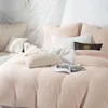 A neatly made bed with several pillows and a book. Podgląd zdjęcia produktu