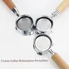 Three bottomless portafilters with wooden handles are arranged on a white background, with text overlay indicating "51mm Coffee Bottomless Portafilter". Náhled obrázku produktu
