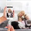A hand holds a smartphone displaying a family photo, while another hand holds a silver USB stick connected to the phone. Náhľad obrázku produktu