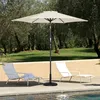An outdoor patio scene with lounge chairs and a patio umbrella next to a pool. Voir les images du produit