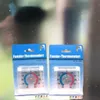 Two window thermometers are shown in their packaging against a blurry background. Produktbild-Vorschau