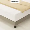 A close-up view of a mattress on its base, with a beige blanket draped over it. Náhľad obrázku produktu