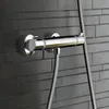 A close-up shot of a chrome shower mixer mounted on a dark gray tiled wall. Náhľad obrázku produktu