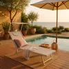 A lounge chair by a pool with a view of the ocean. Produktbild-Vorschau