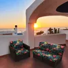 A patio set with cushions on a balcony overlooking the ocean at sunset. Náhled obrázku produktu