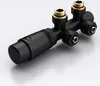 A black radiator valve with gold fittings against a light gray and white background. Produktbild-Vorschau