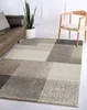 A living room scene with a rug, sofa, and chair. Produktbild-Vorschau