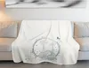 A white blanket with a cartoon elephant and palm trees is draped over a sofa. Produktbild-Vorschau