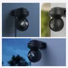 Collage of three images showing a black Reolink E1 Outdoor security camera mounted on a wall in different lighting conditions. Produktbild-Vorschau
