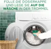 A person is adding detergent to a washing machine. Produktbild-Vorschau