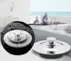 A bathroom sink with a drain stopper, with a bathtub in the background. Produktbild-Vorschau