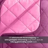 A close-up view of a quilted blanket, showing the stitching and fabric texture. Produktbild-Vorschau