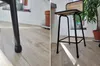 A collage of two images showing details of a bar stool, including its leg cap and the overall structure with a wooden seat and black metal frame. Náhľad obrázku produktu