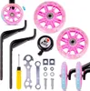 A collection of bicycle training wheels, a bell, and tools are laid out on a white background. Produktbild-Vorschau