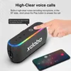A hand is shown pressing a button on a portable speaker, with a smartphone nearby, illustrating a feature. Produktbild-Vorschau
