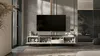 A modern living room with a large television on a media console. A bedroom is visible in the background. Produktbild-Vorschau
