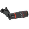 A black and red telephoto lens with a clip attachment, shown against a white background. Náhled obrázku produktu