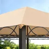 A close-up view of the top corner of a beige gazebo canopy, showing the fabric and metal frame against a blue sky and blurred green trees. Produktbild-Vorschau