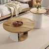 A living room scene with two round coffee tables, a sofa, and a rug. Produktbild-Vorschau