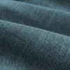A close-up view of textured teal fabric, showing the weave and folds. Produktbild-Vorschau