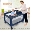 A woman is interacting with a baby in a playpen. Anteprima dell’immagine prodotto