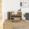 A desk organizer with books, a vase, a clock, and pens on a wooden desk. Voir les images du produit