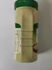 A side view of a beige plastic jar with a green lid, showing nutritional information on a label. Produktbild-Vorschau