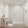 A modern bathroom with a walk-in shower, vanity, and patterned floor tiles. Produktbild-Vorschau