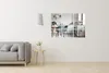 A modern living room with a grey sofa and a small side table, with a multi-panel mirror showing a kitchen scene on the wall. Produktbild-Vorschau