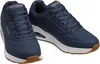 A pair of navy blue Skechers sports shoes with white soles and brown accents on a white background. Náhľad obrázku produktu