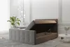 A modern bedroom with a grey upholstered bed frame with the storage compartment open. Produktbild-Vorschau