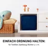 A blue woven storage basket is placed inside a white cube shelf unit, next to a wicker basket with pillows and a whale plush toy. Decorative mushroom figures are on top of the shelf. Podgląd zdjęcia produktu