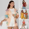 A collage of images showcasing knitted apparel, including a woman wearing a peach cardigan with floral appliques, and smaller images of a red top, a yellow jumpsuit, and a striped dress. Anteprima dell’immagine prodotto
