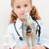 A young girl dressed as a doctor holds a transparent anatomical model of the human body. Anteprima dell’immagine prodotto