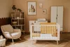A nursery room with a crib, armchair, and shelving unit. Náhľad obrázku produktu