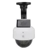 A white and black solar-powered security camera dummy. Produktbild-Vorschau