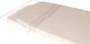 A close-up, angled view of a beige ironing board cover with a decorative gray border pattern, resting on a white wire frame. Produktbild-Vorschau