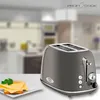 A toaster and a slice of toast with cheese and parsley on a plate, set in a blurred kitchen background. Náhled obrázku produktu