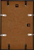 The back of a black picture frame with a brown backing board and various clips and hanging mechanisms. Produktbild-Vorschau