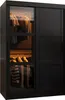 A black sliding door wardrobe with glass panels showing clothes inside. Produktbild-Vorschau