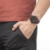 A man's wrist wearing a watch, with his hand in his pocket. Anteprima dell’immagine prodotto